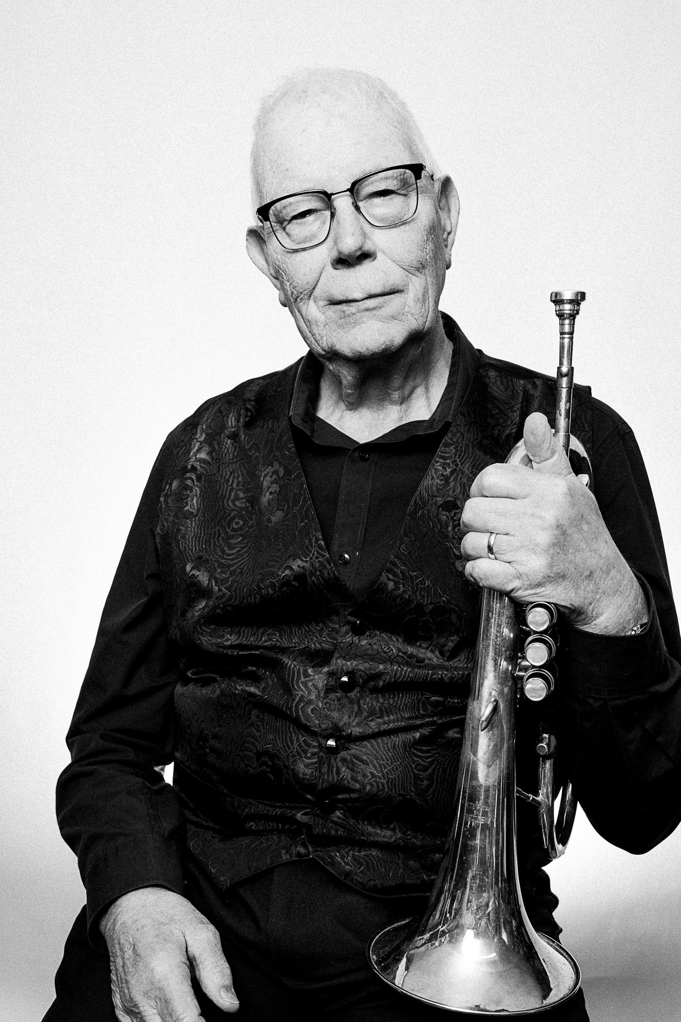Black and white portrait of a musician holding a flugelhorn by Richard Mayle.