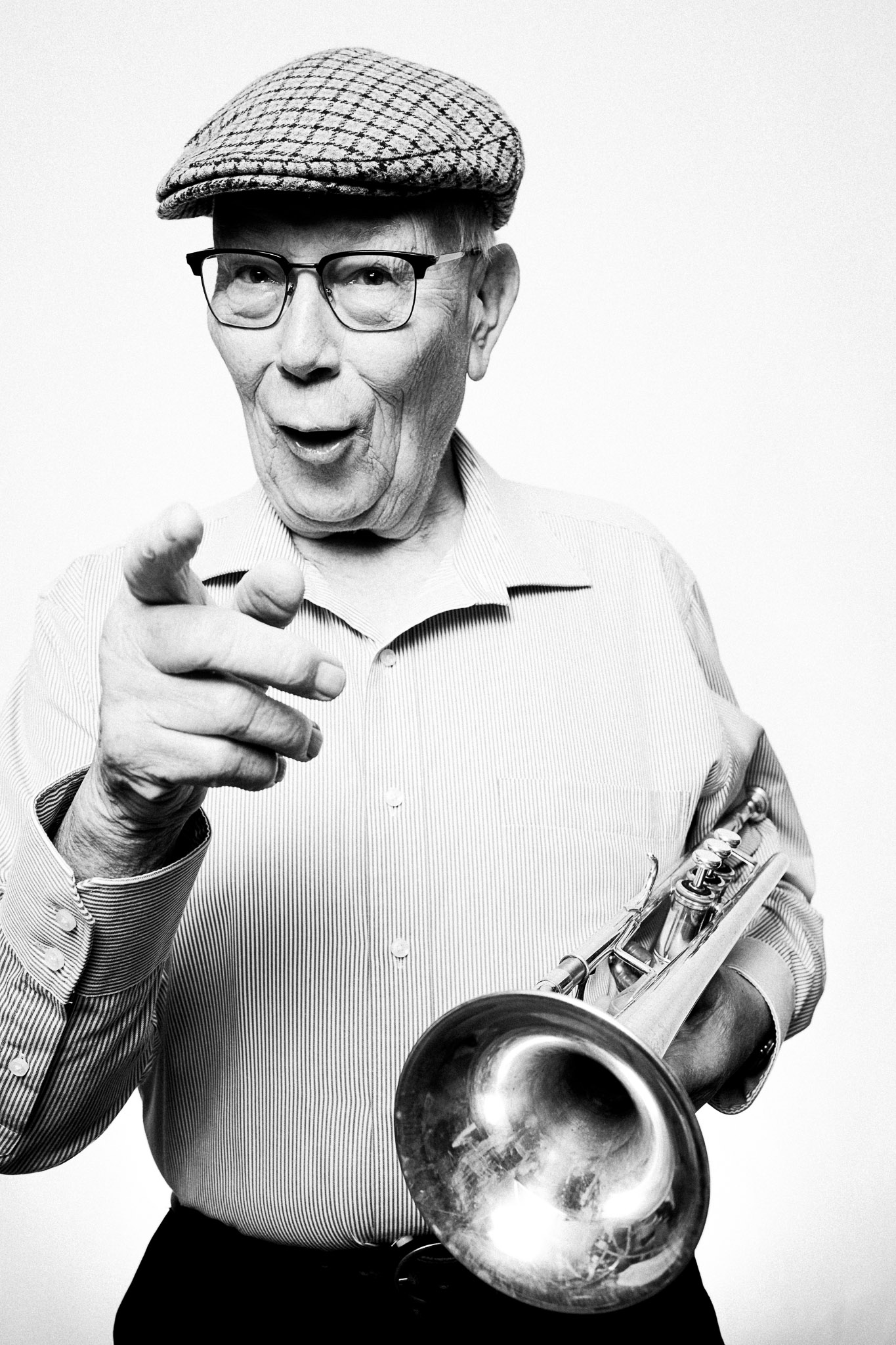 Black and white photograph of a musician holding a trumpet by Richard Mayle.