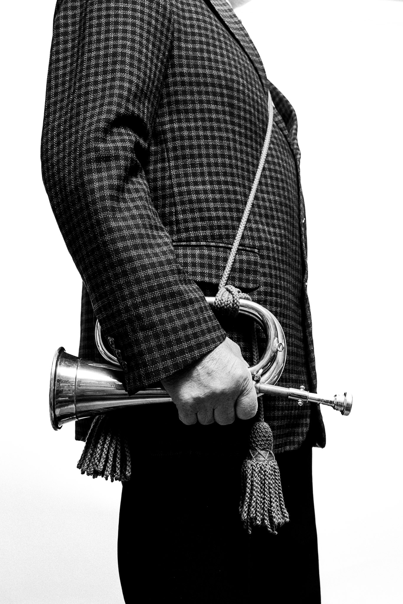 Black and white photograph of a musician holding a bugle by Richard Mayle.