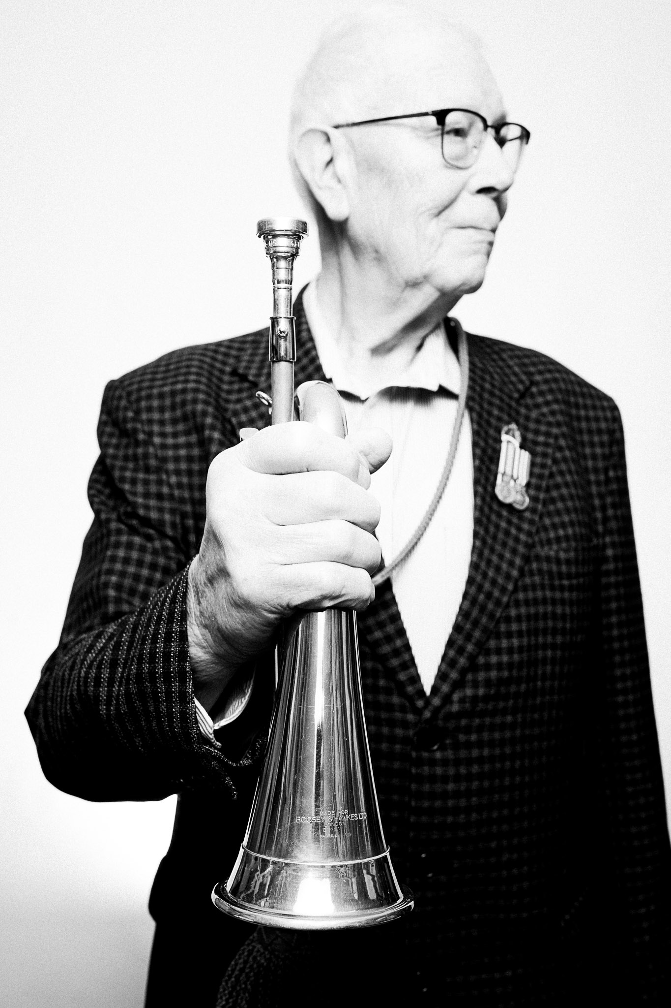 Photograph of a musician holding a bugle by Richard Mayle.