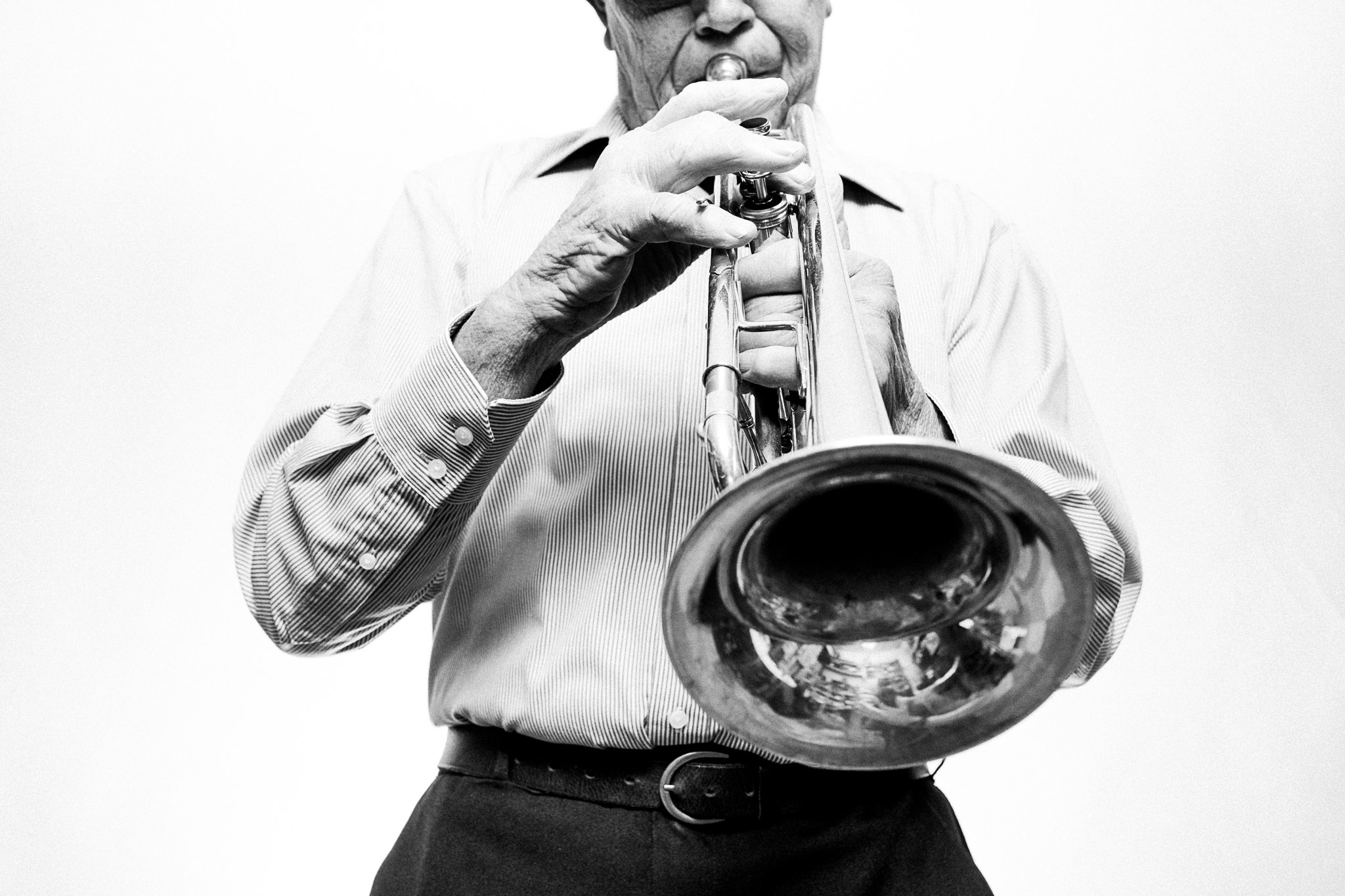 Black and white photograph of a musician playing a trumpet by Richard Mayle.