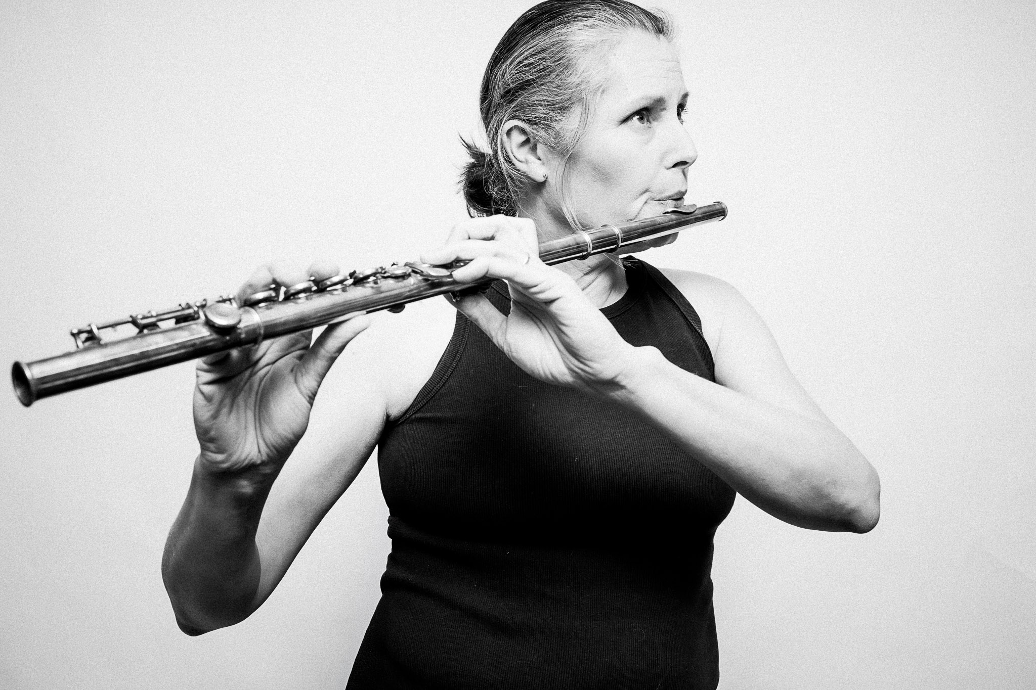 Black and white portrait of a musician playing a flute by Richard Mayle.