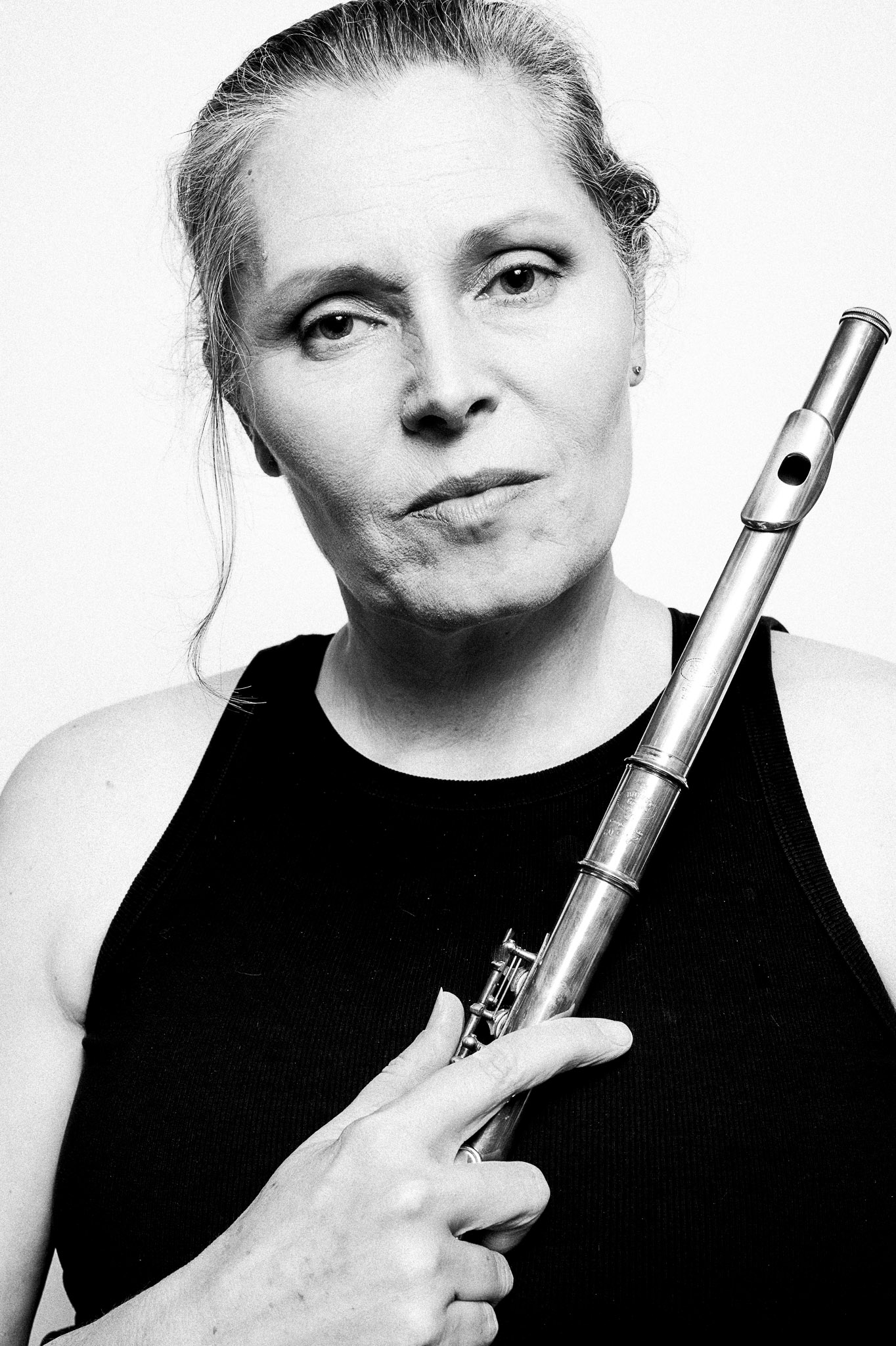 Black and white portrait of a musician holding a flute by Richard Mayle.