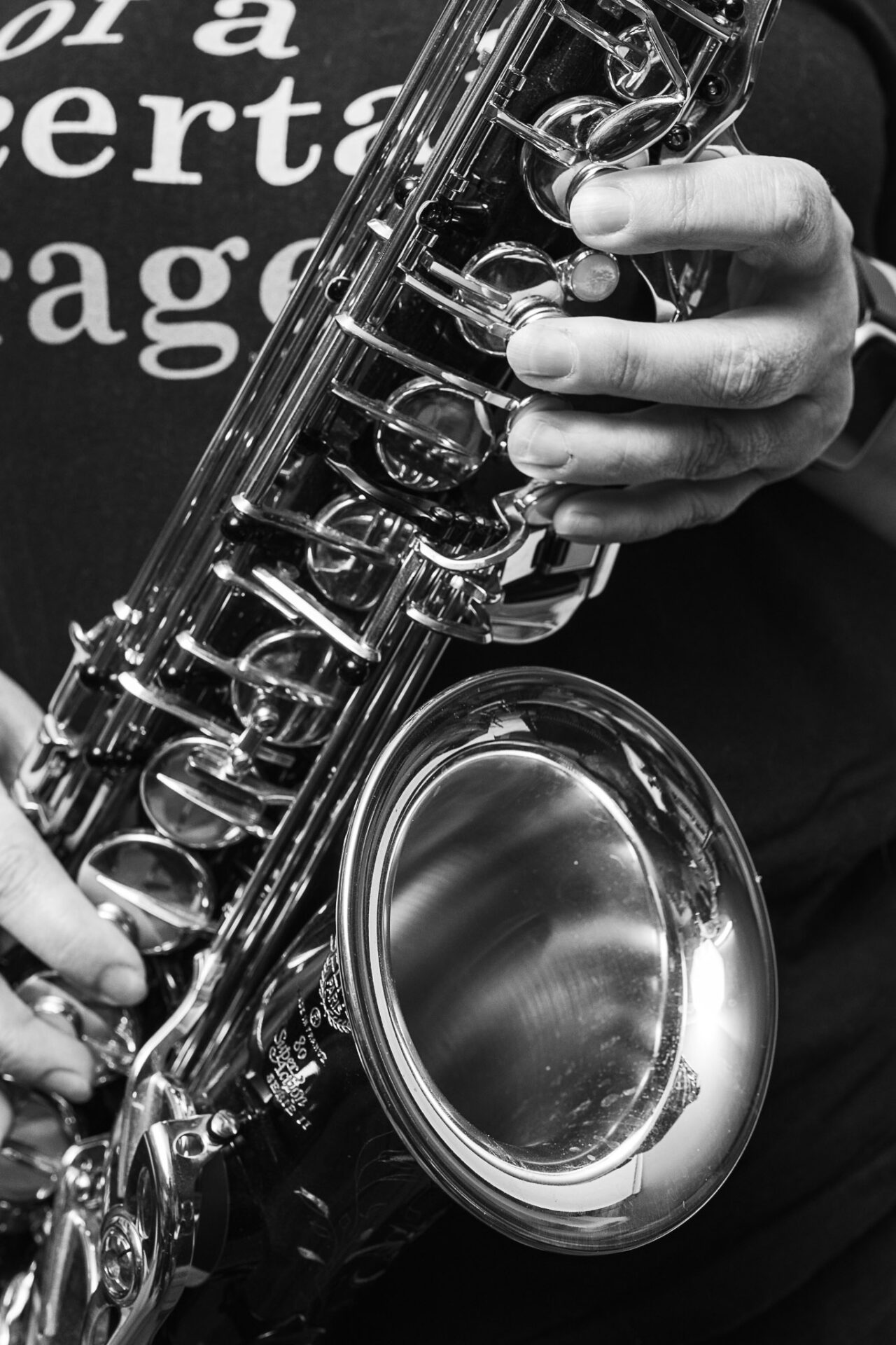 Black and white portrait of a musician holding a saxophone by Richard Mayle.