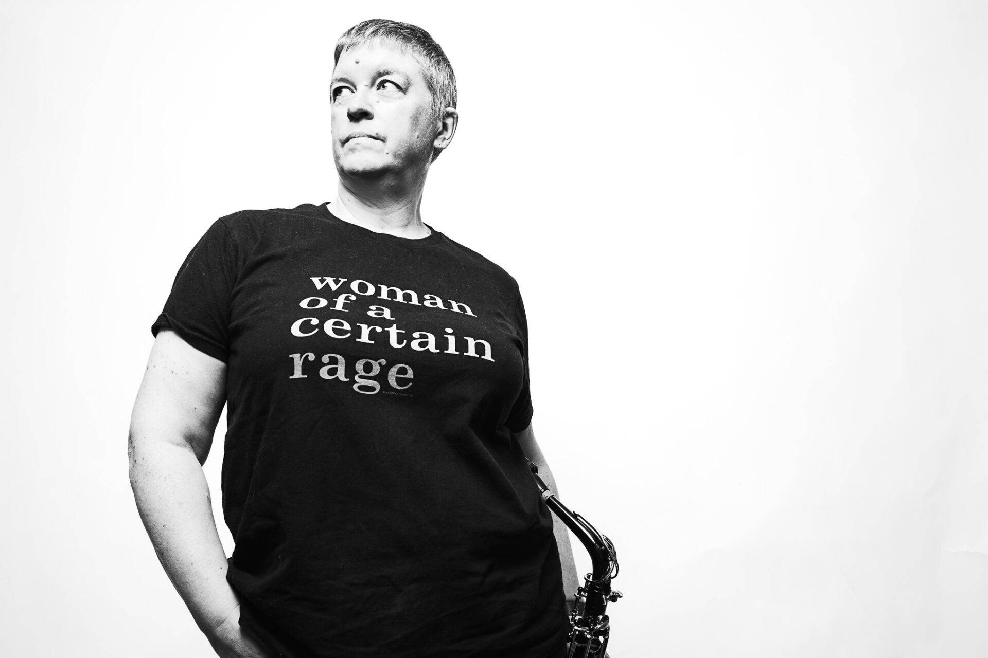 Black and white portrait of a musician holding a saxophone by Richard Mayle.