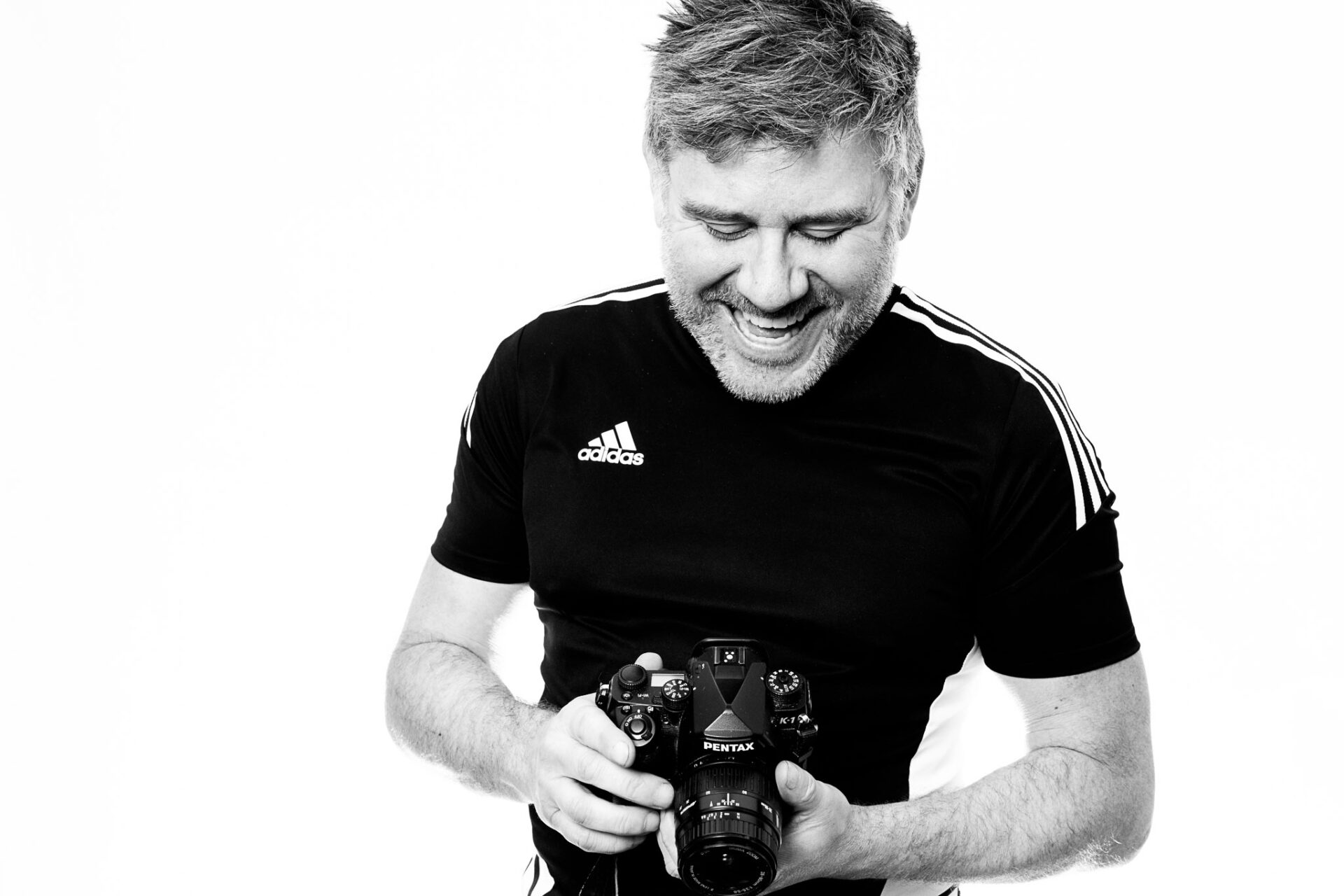 Black and white portrait of Nelson, a photographer, photographed by Richard Mayle.